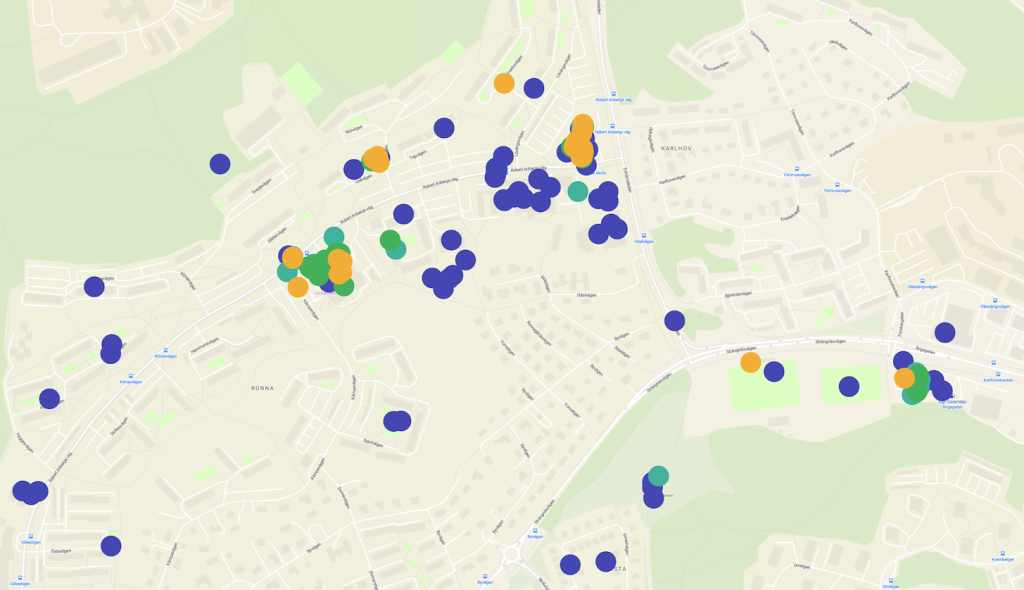 Map of a town with blue, orange, teal, and green markers indicating different site categories; markers clustered in town center and surrounding areas.